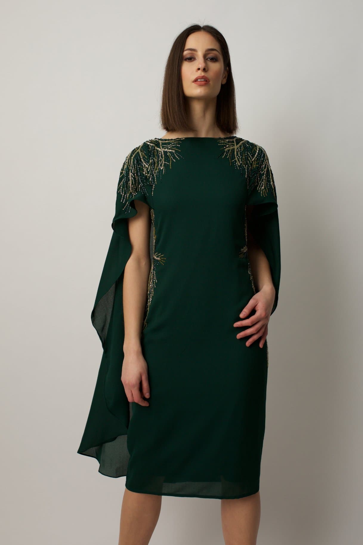 cocktail dress features sublet embroidery on the shoulders and on the sides of the waist