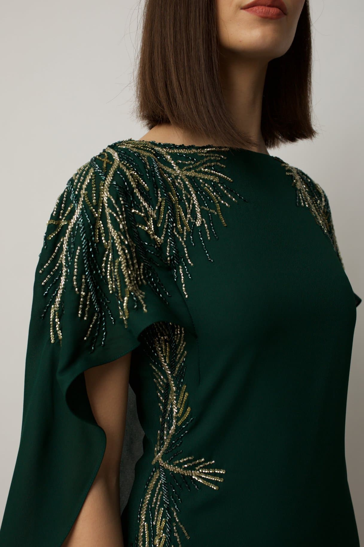 cocktail dress features sublet embroidery on the shoulders and on the sides of the waist